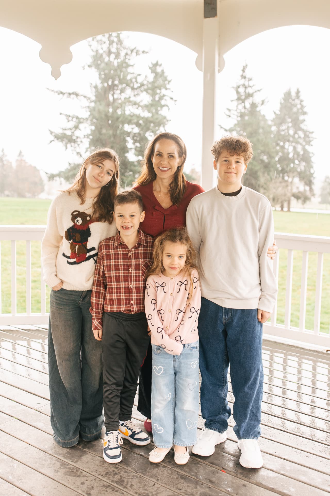 Julia, founder of Ladybug Plush Parties, with her four kids